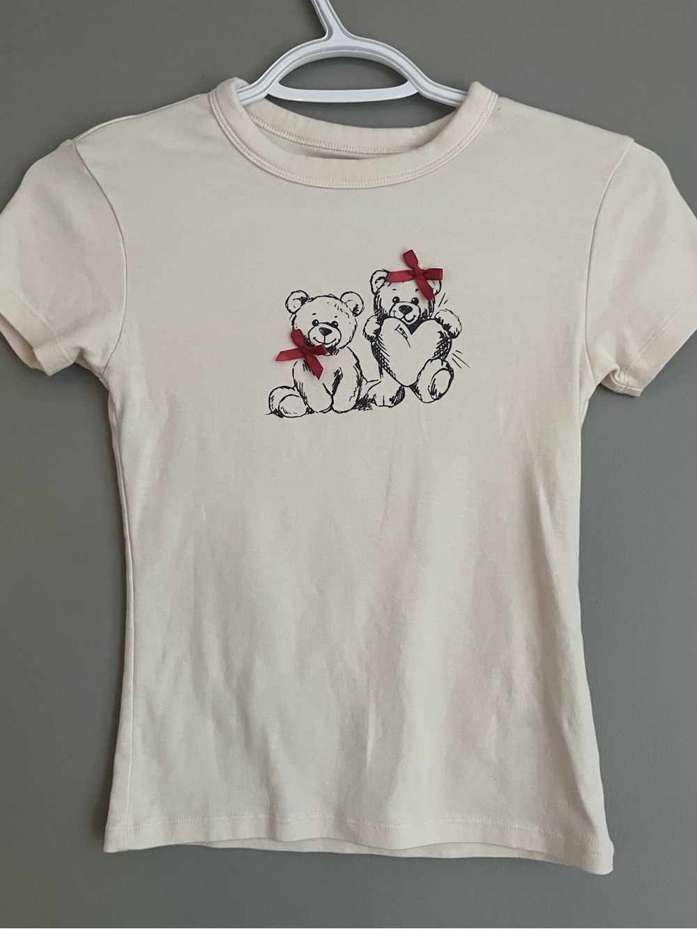 simons cream colored fitted shirt with teddy graphic